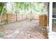 A wood fence surrounds a backyard with some trees and foliage at 1430 Arrowhead Trl, Deltona, FL 32725