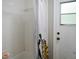 Tiled shower and tub combination with a window providing natural light and ventilation at 1430 Arrowhead Trl, Deltona, FL 32725
