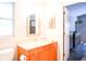 Updated bathroom featuring single vanity with framed mirror and tile floors at 1430 Arrowhead Trl, Deltona, FL 32725
