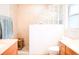 Bright bathroom featuring double vanities, glass block window, and a step-in shower at 1430 Arrowhead Trl, Deltona, FL 32725