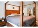 Bedroom featuring a wood four-poster bed, gray linens, and side tables at 1430 Arrowhead Trl, Deltona, FL 32725
