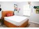 Cozy bedroom featuring a wooden bed frame and natural light from the window at 1430 Arrowhead Trl, Deltona, FL 32725