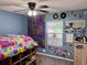 Vibrant bedroom with colorful decor, a ceiling fan, and natural light from the window at 1430 Arrowhead Trl, Deltona, FL 32725