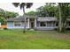 Inviting single-story home featuring a covered front porch and a neatly kept lawn at 1430 Arrowhead Trl, Deltona, FL 32725