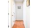 Bright hallway with hardwood floors and neutral paint, leading to various rooms in the home at 1430 Arrowhead Trl, Deltona, FL 32725