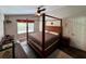 Spacious main bedroom with a four-poster bed, neutral walls, and view of the landscaped yard at 1430 Arrowhead Trl, Deltona, FL 32725