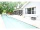 An in-ground pool is adjacent to the home's screened-in back porch at 1430 Arrowhead Trl, Deltona, FL 32725