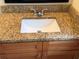 Close up of a bathroom vanity featuring granite countertops, modern faucet, and raised-panel cabinet doors at 14844 Laguna Beach Cir, Orlando, FL 32824