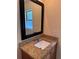 Bathroom vanity with granite countertop, framed mirror, and bright window, creating a clean and inviting space at 14844 Laguna Beach Cir, Orlando, FL 32824