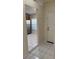 View of the bright kitchen from the entryway with tile floors and stainless steel appliances at 14844 Laguna Beach Cir, Orlando, FL 32824