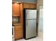 Stainless steel refrigerator is nestled alongside window with plenty of natural light at 14844 Laguna Beach Cir, Orlando, FL 32824