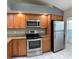 Updated kitchen features stainless steel appliances, ample counter space, and bright lighting at 14844 Laguna Beach Cir, Orlando, FL 32824