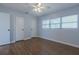 Bedroom with ceiling fan, window, and plank flooring at 151 N Orlando Ave # 204, Winter Park, FL 32789