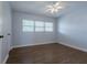 A simple bedroom featuring a window, ceiling fan and luxury vinyl plank flooring at 151 N Orlando Ave # 204, Winter Park, FL 32789