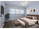 Comfortable bedroom featuring a modern ceiling fan, luxury flooring, and bright natural light from a window at 151 N Orlando Ave # 204, Winter Park, FL 32789