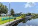 Inviting community area by the lake with Adirondack chairs and grilling station, ideal for gatherings at 151 N Orlando Ave # 204, Winter Park, FL 32789
