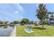 Relaxing community area by the water with benches and a picnic table for outdoor enjoyment at 151 N Orlando Ave # 204, Winter Park, FL 32789