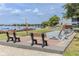 Community area featuring benches, lounging chairs and a shuffleboard court with scenic water views at 151 N Orlando Ave # 204, Winter Park, FL 32789