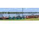 Picturesque view of lakefront docks with cozy Adirondack chairs, perfect for enjoying waterfront activities at 151 N Orlando Ave # 204, Winter Park, FL 32789