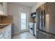 Efficient kitchen includes stainless steel appliances and access to outdoor space at 151 N Orlando Ave # 204, Winter Park, FL 32789
