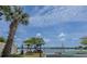 Scenic lake view with a palm tree and boat storage racks, perfect for waterfront living at 151 N Orlando Ave # 204, Winter Park, FL 32789
