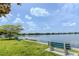 Peaceful lake view with inviting green space and seating, ideal for relaxation at 151 N Orlando Ave # 204, Winter Park, FL 32789