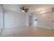 Bright and airy living room with ceiling fan and tile flooring, flowing into the kitchen at 151 N Orlando Ave # 204, Winter Park, FL 32789