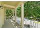 A spacious balcony with elegant columns provides a serene view of the lush green landscape, perfect for relaxation at 1630 Common Way Rd # 203, Orlando, FL 32814