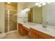 A bathroom with double sinks, shower, and ample vanity space at 1630 Common Way Rd # 203, Orlando, FL 32814