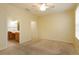 A carpeted bedroom with an en suite bathroom and walk-in closet at 1630 Common Way Rd # 203, Orlando, FL 32814