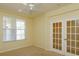 A naturally lit bedroom with carpet flooring and access to a balcony at 1630 Common Way Rd # 203, Orlando, FL 32814