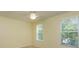 A light-filled bedroom with carpet flooring, neutral walls, and two windows at 1630 Common Way Rd # 203, Orlando, FL 32814