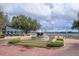 An outdoor area featuring a fountain with manicured flower beds with lake view, perfect for leisure and relaxation at 1630 Common Way Rd # 203, Orlando, FL 32814