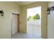 A common area featuring elevator access, enhanced by wall sconces, and a window offering a view of the neighborhood at 1630 Common Way Rd # 203, Orlando, FL 32814