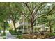 Beautiful multi-story home with multiple balconies, lush landscaping, and mature shade trees create an inviting and picturesque setting at 1630 Common Way Rd # 203, Orlando, FL 32814