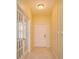 Inviting foyer with tile flooring, glass paneled doors, and neutral paint, enhancing the home's bright and welcoming ambiance at 1630 Common Way Rd # 203, Orlando, FL 32814