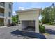 A detached one-car garage with an open door, offering parking and storage space, next to the main building at 1630 Common Way Rd # 203, Orlando, FL 32814