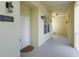 Well-lit hallway featuring unit number, sconce lighting, and access to a stairwell with a neutral color palette and clean finishes at 1630 Common Way Rd # 203, Orlando, FL 32814