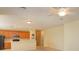 A sun-filled living room provides a look into the kitchen and an adjacent hallway at 1630 Common Way Rd # 203, Orlando, FL 32814