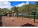 A fenced community playground with multiple slides and swingsets offering a safe recreational area for families at 1630 Common Way Rd # 203, Orlando, FL 32814