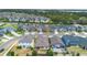 Bird's-eye view of homes and a street in a neighborhood featuring well-maintained lawns at 17199 Hickory Wind Dr, Clermont, FL 34711