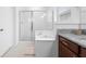 Bright bathroom with a shower, tub, granite vanity, and soft rug at 17199 Hickory Wind Dr, Clermont, FL 34711
