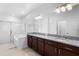 Bright bathroom featuring a dual sink vanity with granite countertops and a separate tub and shower at 17199 Hickory Wind Dr, Clermont, FL 34711
