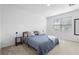 Well-lit bedroom featuring a comfortable bed and minimalist decor, creating a relaxing space at 17199 Hickory Wind Dr, Clermont, FL 34711