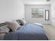 Minimalist bedroom featuring a comfortable bed and neutral decor, creating a serene atmosphere at 17199 Hickory Wind Dr, Clermont, FL 34711