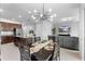 Bright dining area open to kitchen with island and comfortable living space with large screen TV at 17199 Hickory Wind Dr, Clermont, FL 34711