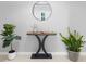 Chic foyer featuring a modern console table, round mirror and decorative plants at 17199 Hickory Wind Dr, Clermont, FL 34711