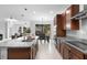 Spacious kitchen with stainless appliances, granite countertops, island and easy access to the dining area at 17199 Hickory Wind Dr, Clermont, FL 34711