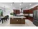 Modern kitchen featuring an island with pendant lighting and stainless steel appliances at 17199 Hickory Wind Dr, Clermont, FL 34711