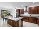 Stylish kitchen with island featuring wood accents, granite countertops, and modern appliances at 17199 Hickory Wind Dr, Clermont, FL 34711